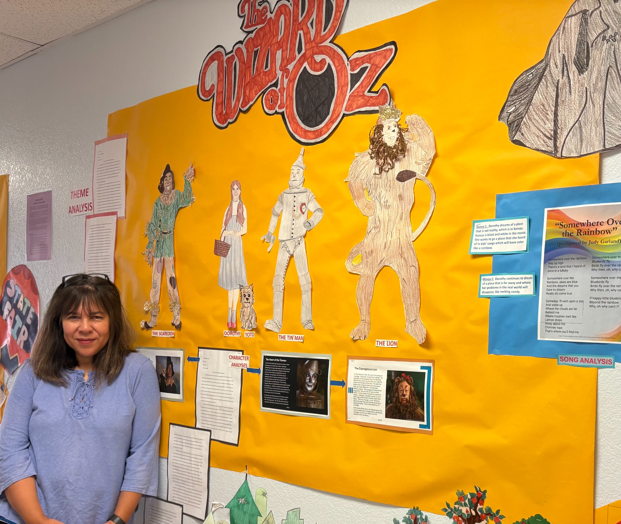 Leslie Simmons in front of a student-created Wizard of Oz classroom display