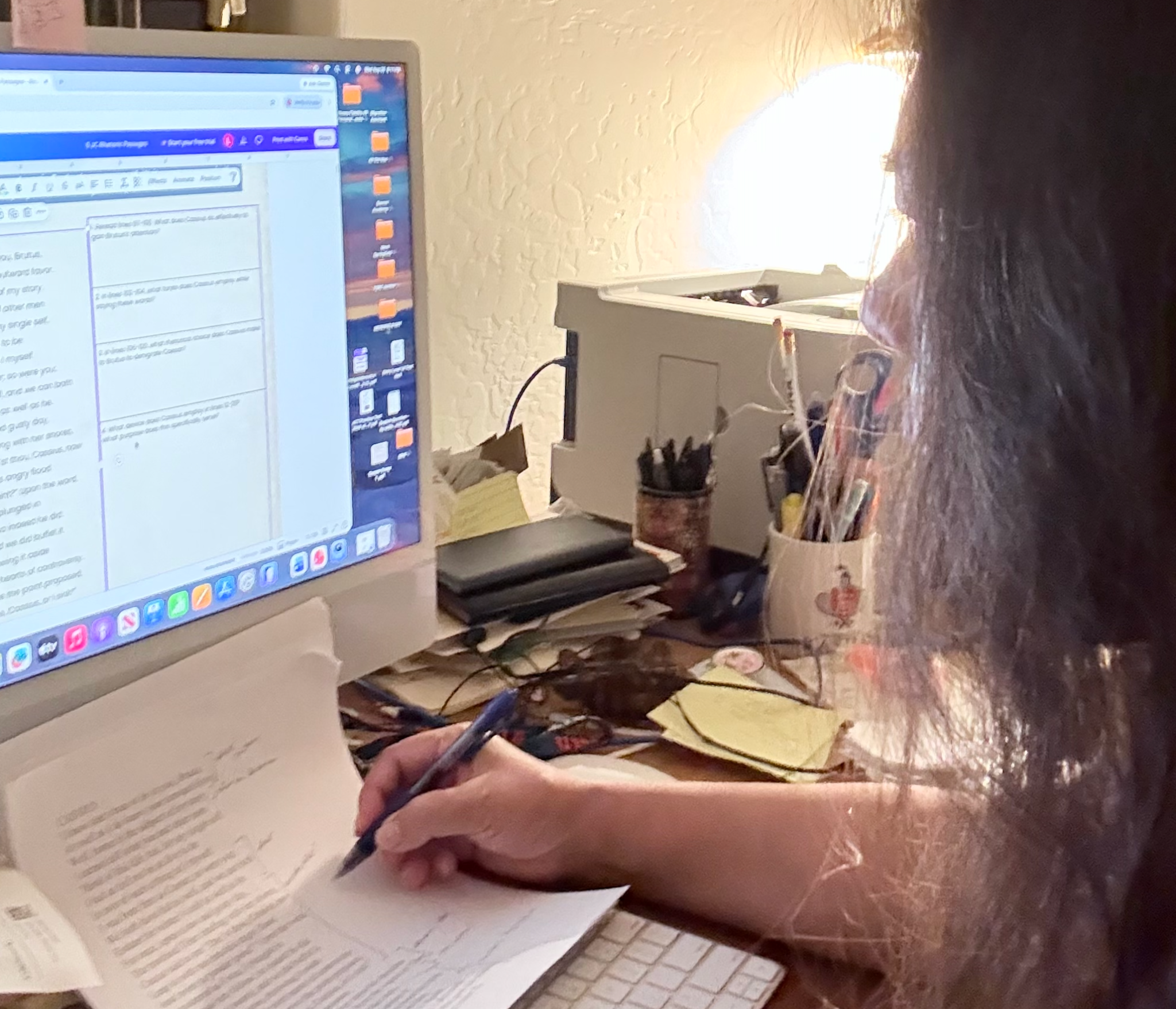 Leslie working at her desk on a Julius Caesar rhetoric project